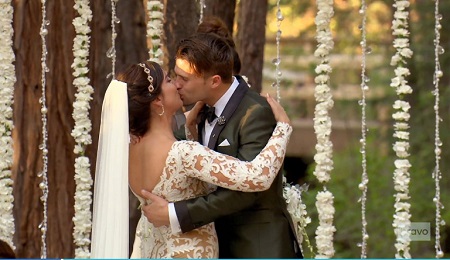 Katie Maloney and Tom Schwartz kissing each other at their wedding