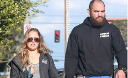 Ronda Rousey is currently dating Travis Browne: He is still married to Jenna Renee Webb. Have two children with her: Was accused of physical violence 